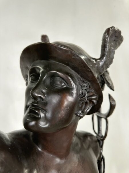 Close up of face of the bronze Flying Mercury messenger of the gods
